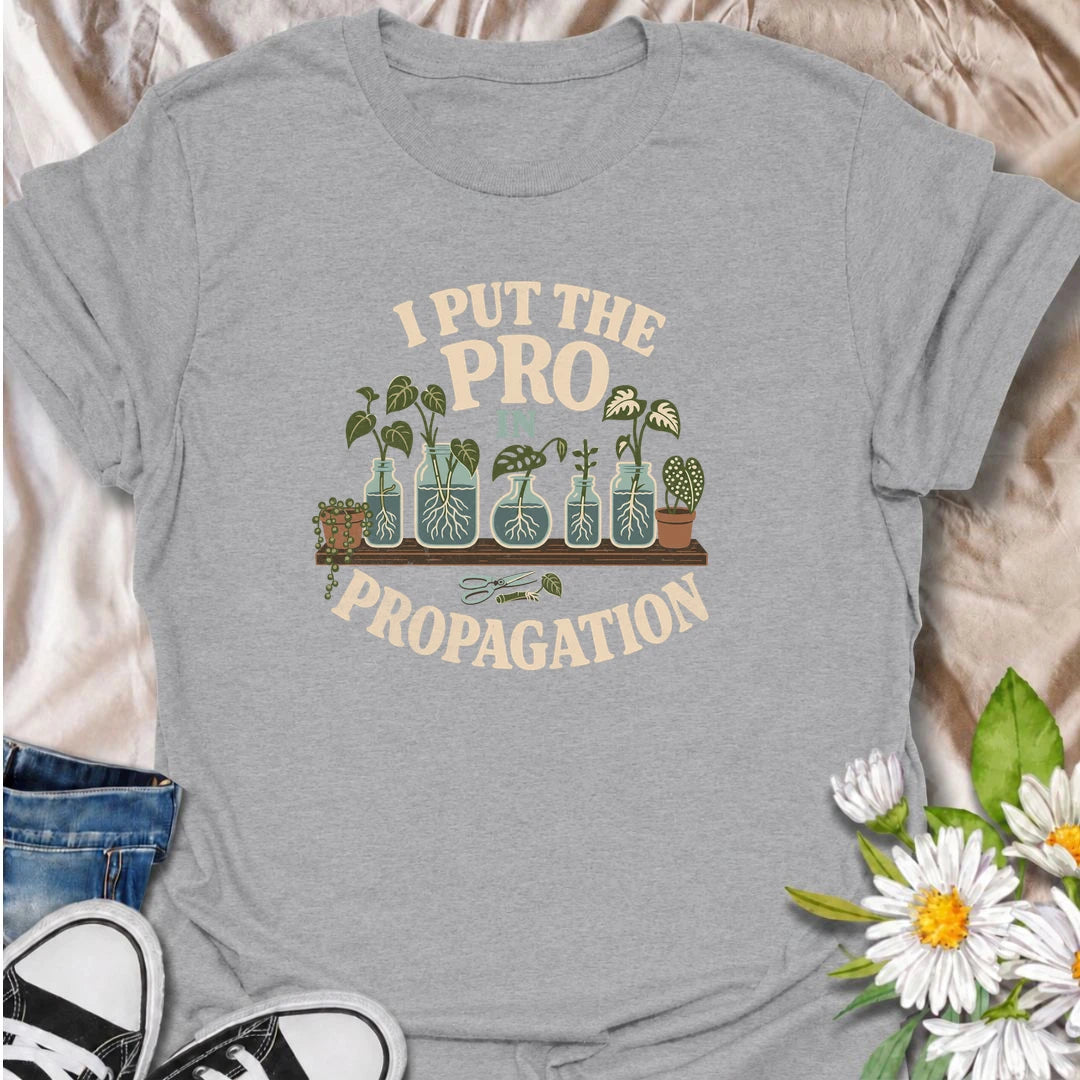 A funny propagation T-shirt for houseplant lovers who have turned rooting cuttings into a full-time hobby. Featuring plant cuttings growing in water-filled jars, this design is made for pothos fans, plant parents, and indoor gardeners. The playful “I Put the Pro in Propagation” phrase makes it a great gift for anyone with a growing collection of propagated plants. Perfect for plant swaps, nursery trips, greenhouse days, or simply showing off your houseplant obsession. A fun botanical graphic tee for anyone 
