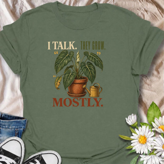 Funny plant lover T-shirt for anyone who talks to their houseplants and likes to believe it helps. Featuring a large vintage potted plant and playful “I Talk. They Grow. Mostly.” wording, this is a fun shirt for indoor gardeners, plant parents and enthusiastic houseplant collectors.