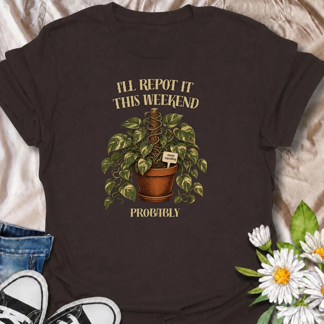 A funny plant T-shirt for anyone who keeps putting off that repotting job for just one more day. Featuring a lush trailing houseplant in a terracotta pot with a cheeky “Needs Repotting” tag, this design is perfect for plant parents and indoor gardeners. The phrase “I’ll Repot It This Weekend. Probably.” captures the procrastination every houseplant lover knows too well. It makes a great gift for pothos fans, plant collectors, and anyone with a growing list of plant-care jobs. Ideal for nursery trips, plant 
