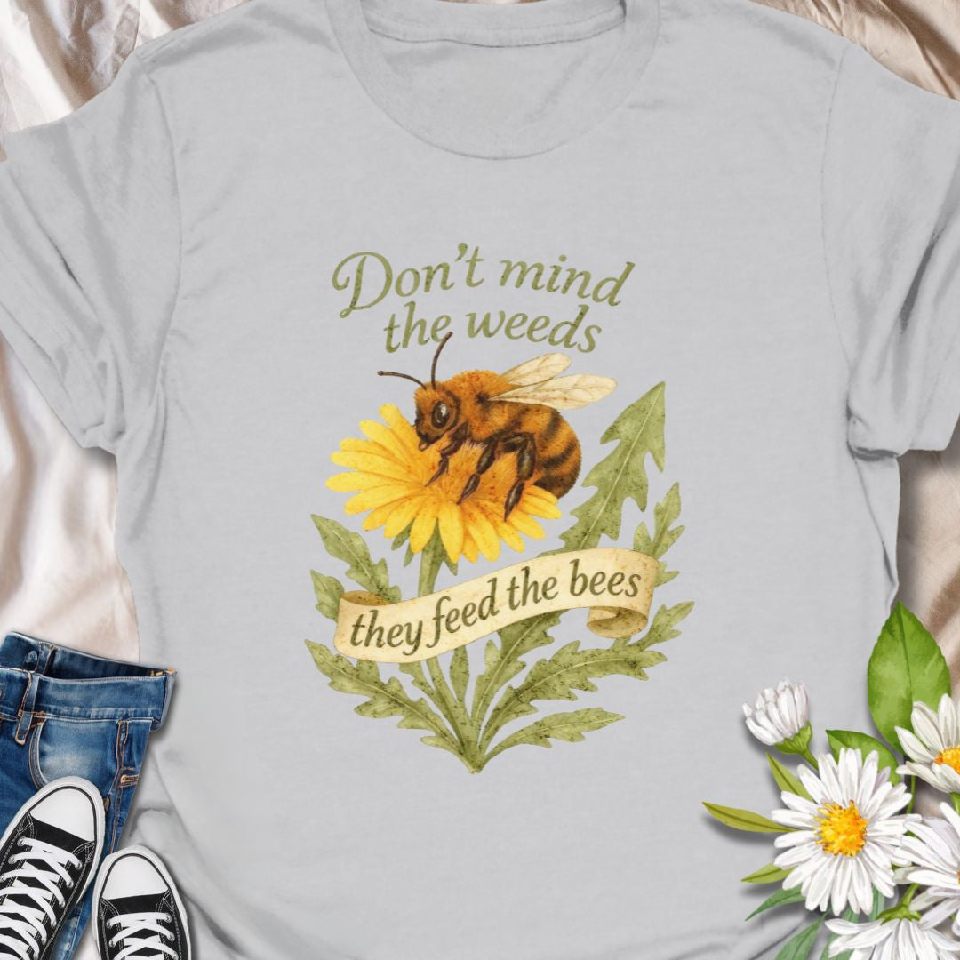 Support pollinators in style with this charming “Don’t Mind the Weeds, They Feed the Bees” t-shirt. Featuring a hand-drawn bee and dandelion artwork, this eco-friendly message tee is perfect for gardeners, nature lovers, and bee advocates who know weeds can be beautiful too.