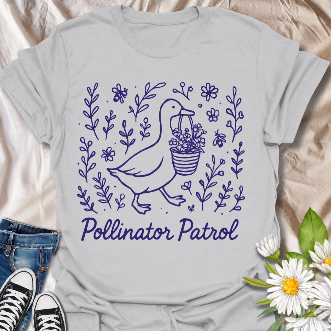 Charming ‘Pollinator Patrol’ goose shirt featuring a goose carrying flowers surrounded by bees and blooms. Perfect for gardeners, beekeepers, and wildlife conservation enthusiasts
