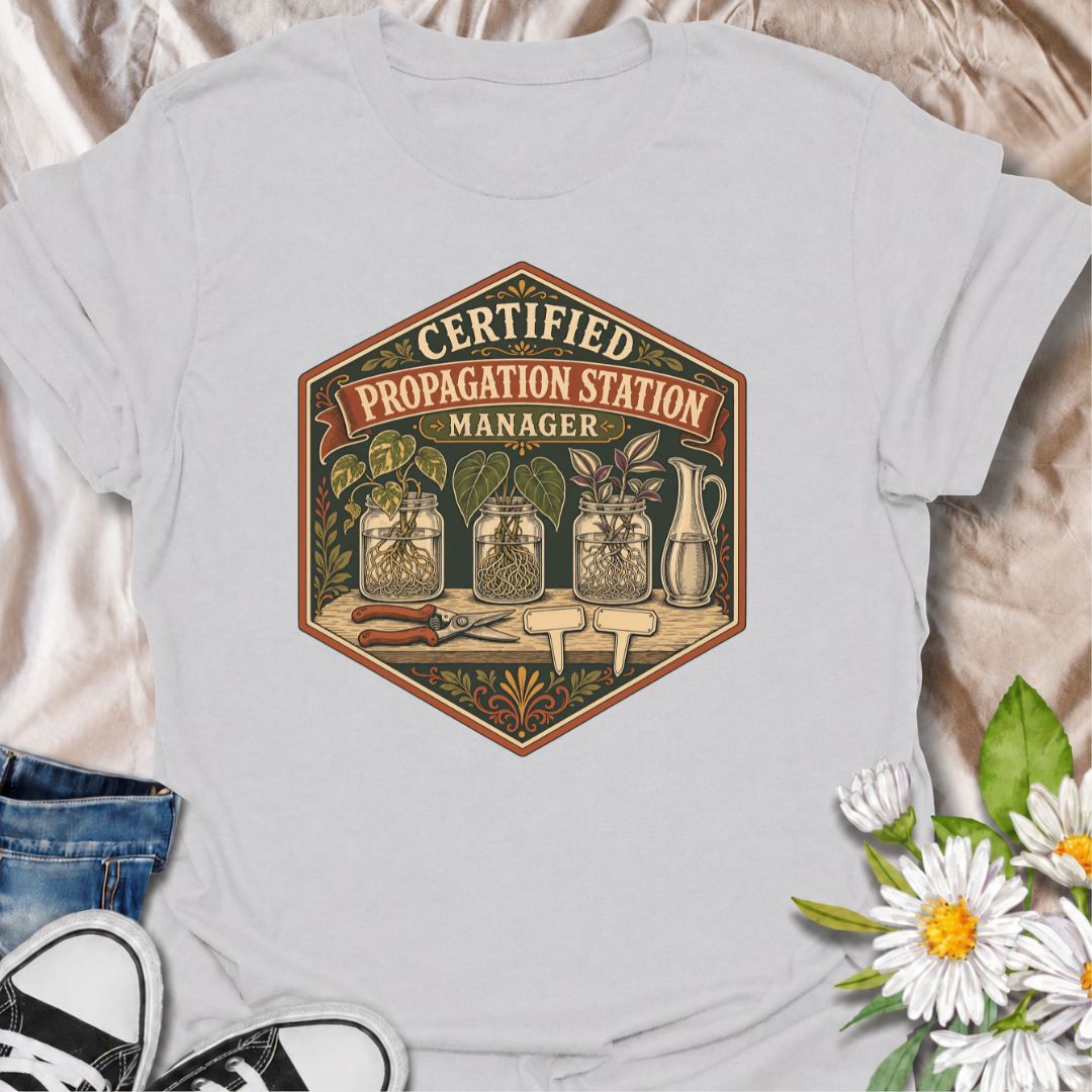 Show off your plant-growing expertise with this “Certified Propagation Station Manager” T-shirt. Featuring rooted cuttings in glass jars, plant markers, pruning shears, and a vintage badge-style design, it is perfect for plant lovers who always have a propagation project underway. A fun gift for houseplant collectors, plant moms, and indoor gardeners.