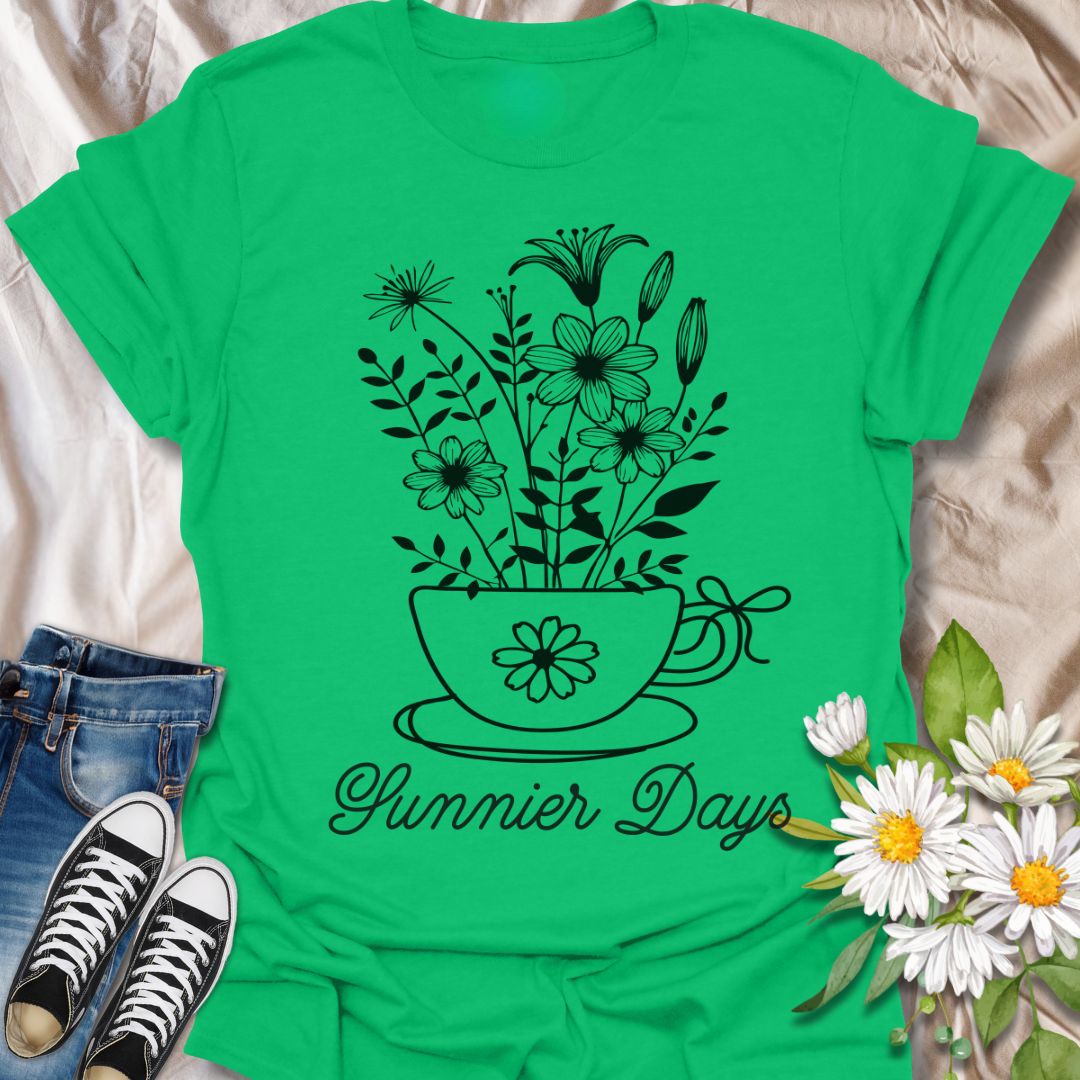 Charming floral t-shirt featuring hand-drawn white flowers blooming from a teacup with the words “Sunnier Days.” A cozy, uplifting design for flower lovers, tea drinkers, and anyone who embraces the simple joys of life. Great gift for gardeners and sunny souls.