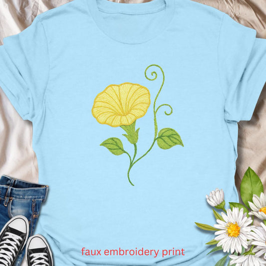 Add a touch of garden charm to your outfit with this faux embroidery t-shirt featuring a delicate yellow morning glory flower. Designed with a stitched-look finish, this nature-inspired tee is perfect for plant lovers, gardeners, and fans of floral simplicity. A soft, botanical vibe for everyday wear or gifting.