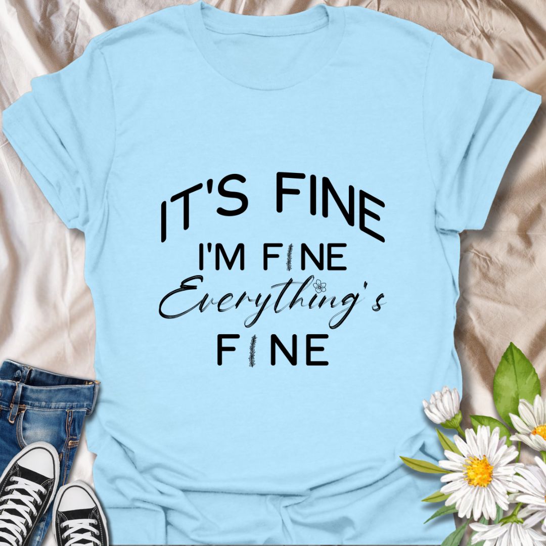Keep it together (barely) with this humorous “It’s Fine. I’m Fine. Everything’s Fine” t-shirt. A relatable design with playful typography and a subtle floral touch—perfect for those who handle chaos with a smile.