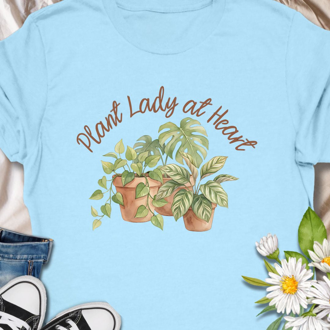 Celebrate your love for greenery with this charming “Plant Lady at Heart” t-shirt. Featuring soft water color-style potted plants and elegant script text, it’s the perfect gift for plant moms, gardeners, and nature enthusiasts. Wear it proudly and show the world that your heart truly belongs to plants—comfort meets style in this must-have tee.