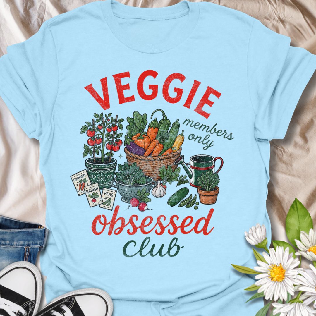 This Veggie Obsessed Club t-shirt is perfect for gardeners, vegetable lovers, and homegrown food fans. Featuring a colorful illustrated harvest scene with tomatoes, carrots, cucumbers, seed packets, and a watering can, this fun gardening tee is great for anyone who loves growing their own food and spending time in the garden.