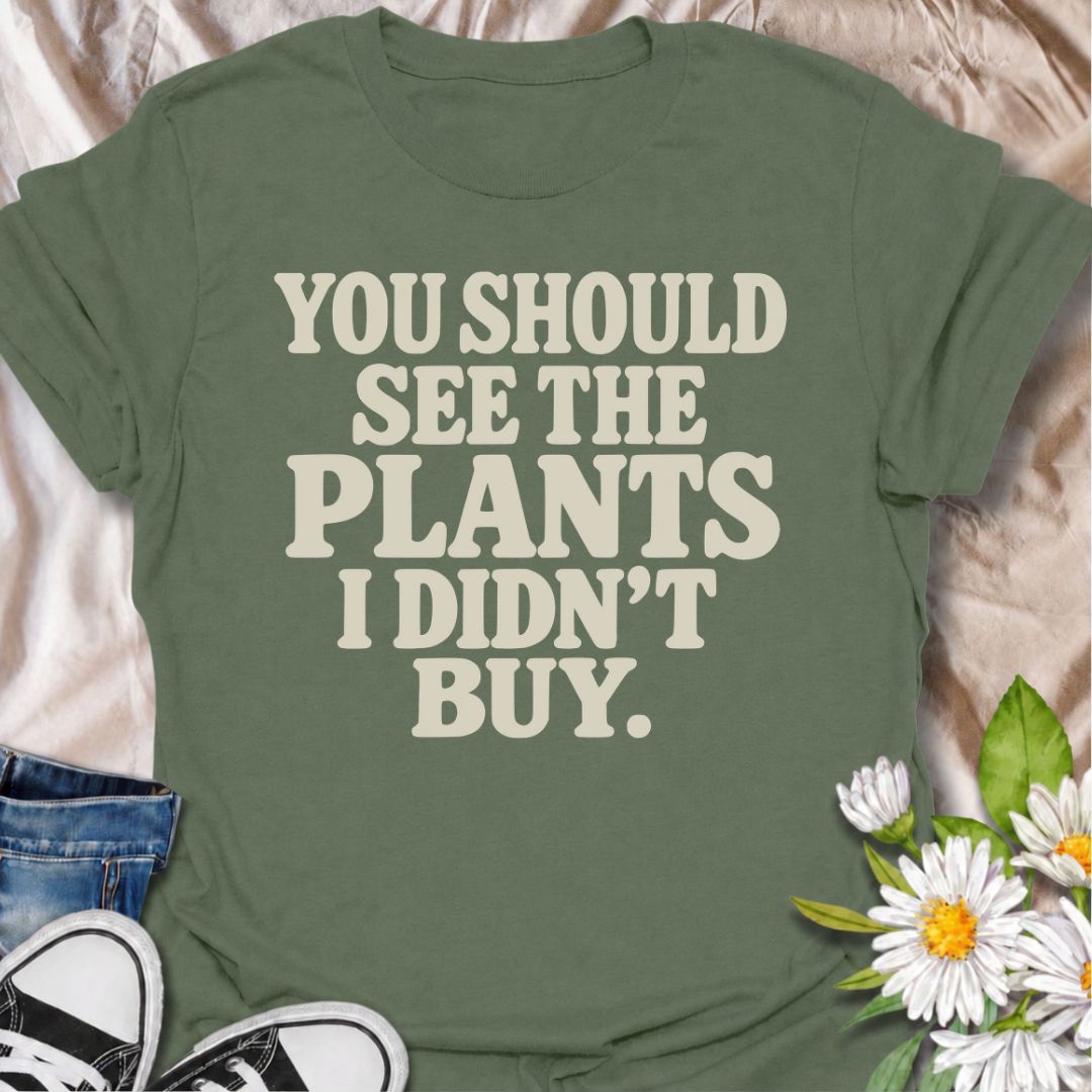 A funny plant T-shirt for anyone whose restraint deserves at least a little recognition. The phrase “You Should See the Plants I Didn’t Buy” delivers dry, self-aware humor that plant parents, nursery regulars, and houseplant collectors will instantly understand. Its bold retro typography keeps the design simple, readable, and easy to wear. It makes a great gift for plant lovers who somehow manage to leave the garden center with fewer plants than they wanted. Perfect for nursery trips, plant swaps, casual we