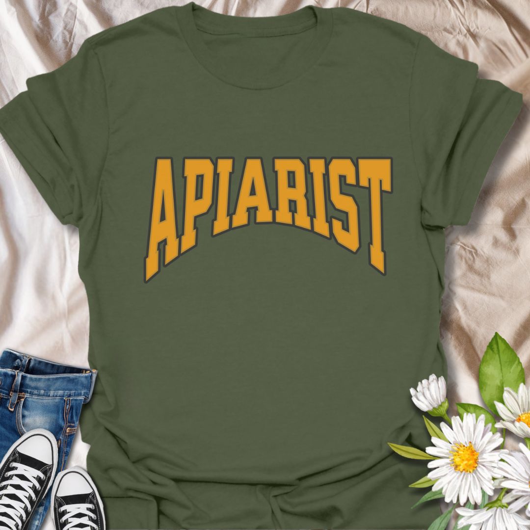 Simple bold "Apiarist" t-shirt with collegiate-style yellow lettering on black. Perfect for professional beekeepers, hobbyist beekeepers, honey producers, and bee conservation advocates. Great gift for anyone passionate about apiculture, bee science, or protecting pollinators.