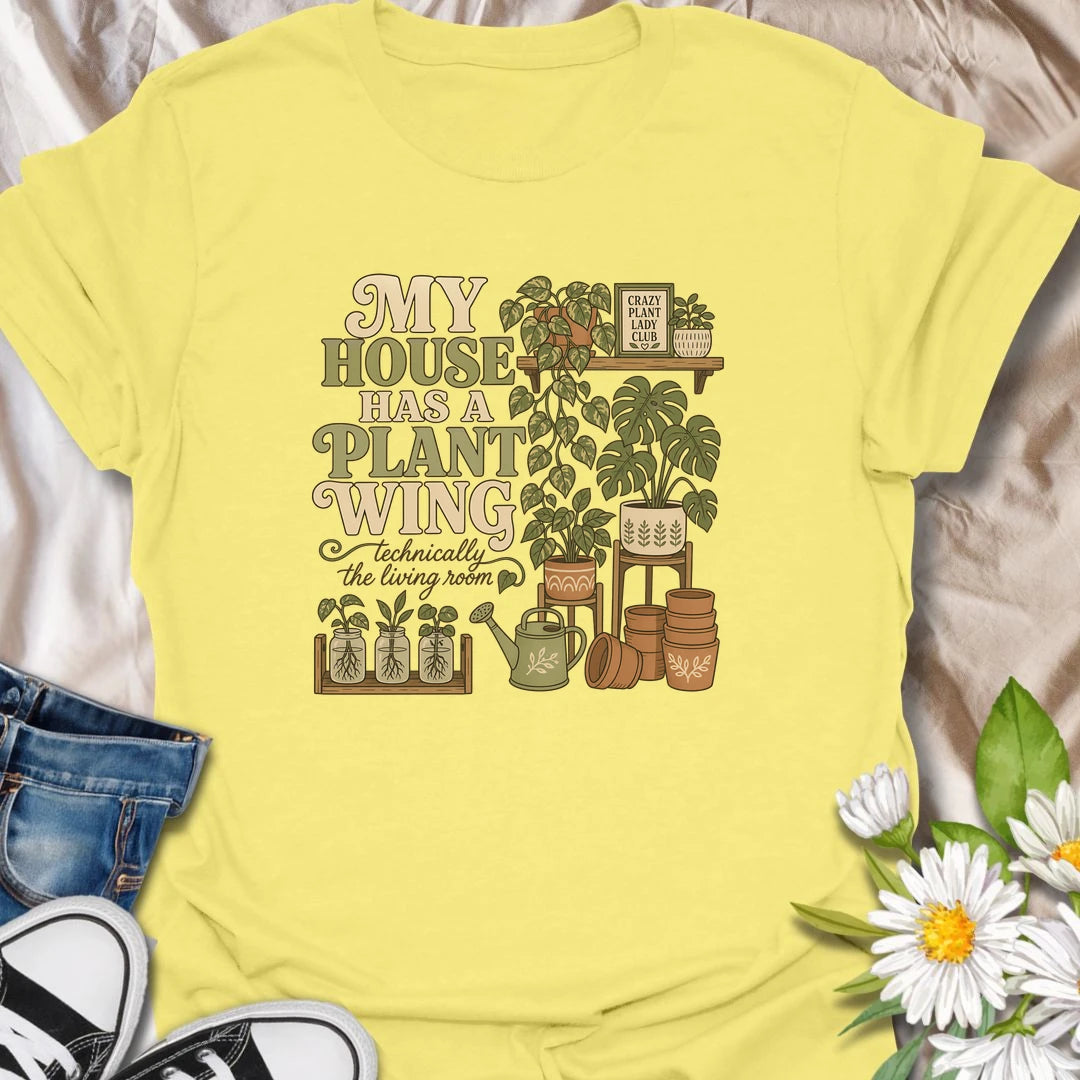 A funny houseplant T-shirt for anyone whose living room has gradually become a dedicated indoor garden. The design features overflowing plant shelves, propagation jars, watering supplies, and stacks of terracotta pots. A charming gift for indoor gardeners, plant moms, and collectors with greenery in every room.