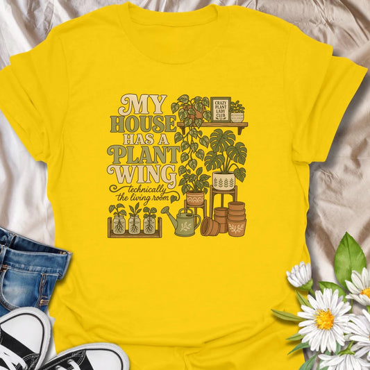 A funny houseplant T-shirt for anyone whose living room has gradually become a dedicated indoor garden. The design features overflowing plant shelves, propagation jars, watering supplies, and stacks of terracotta pots. A charming gift for indoor gardeners, plant moms, and collectors with greenery in every room.
