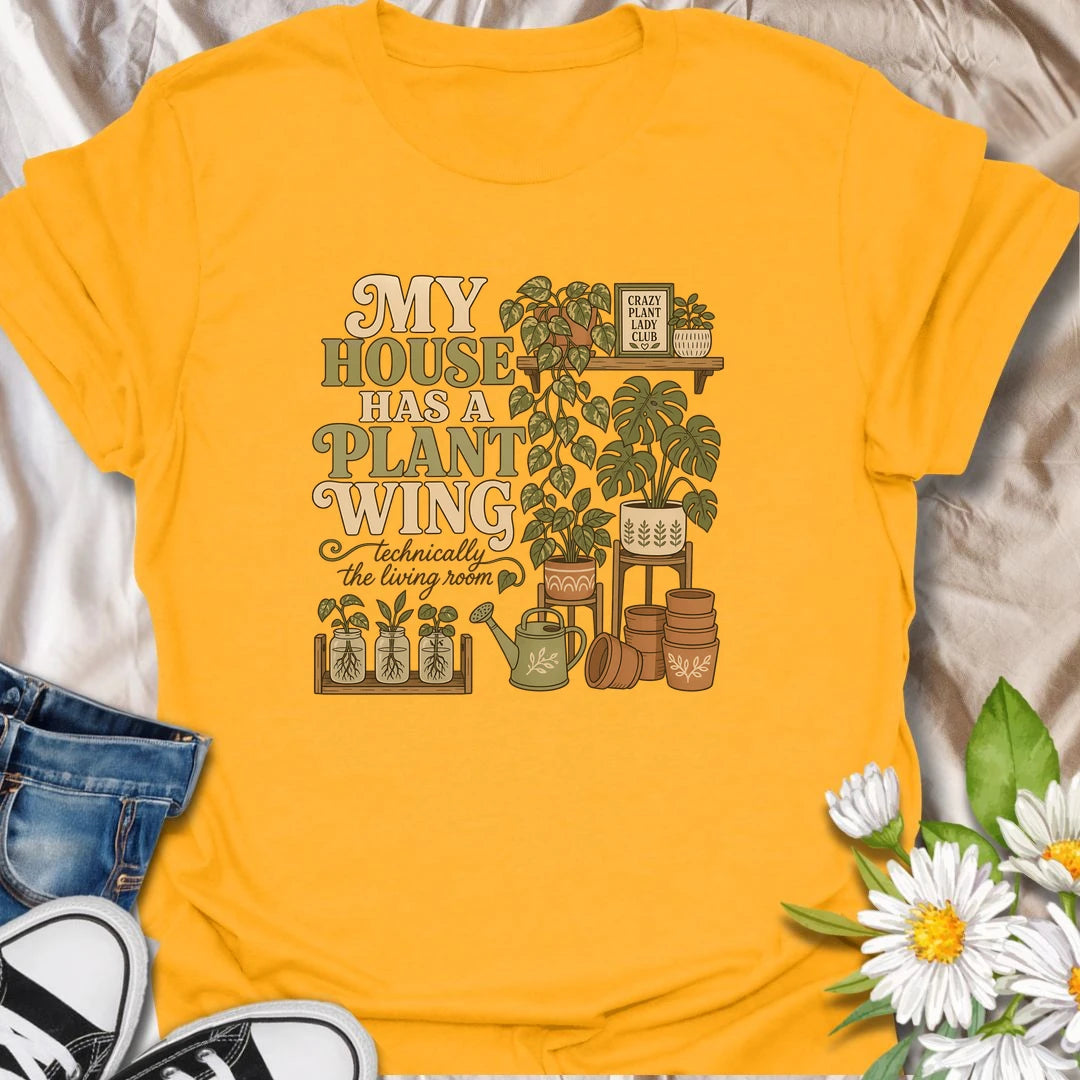 A funny houseplant T-shirt for anyone whose living room has gradually become a dedicated indoor garden. The design features overflowing plant shelves, propagation jars, watering supplies, and stacks of terracotta pots. A charming gift for indoor gardeners, plant moms, and collectors with greenery in every room.