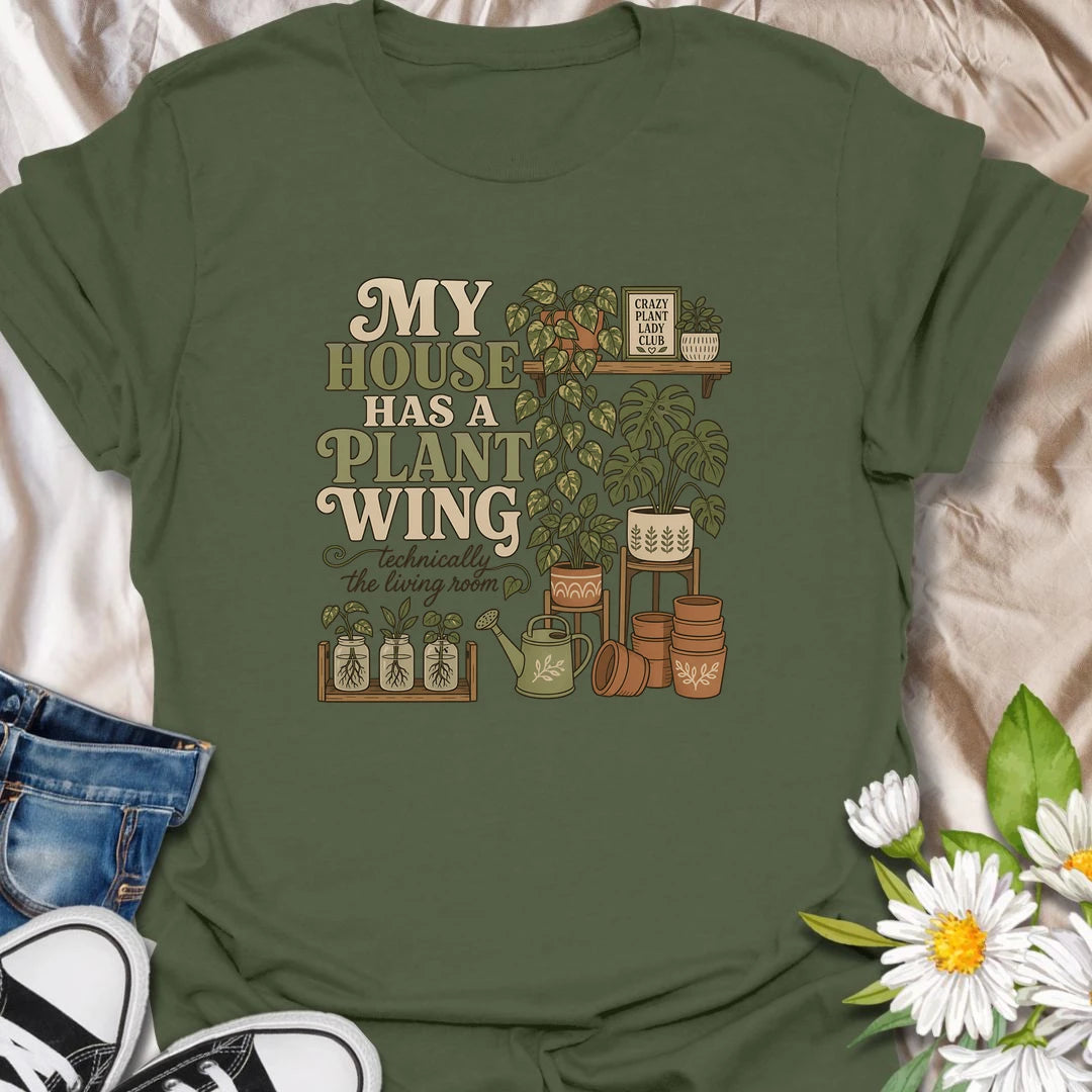 A funny houseplant T-shirt for anyone whose living room has gradually become a dedicated indoor garden. The design features overflowing plant shelves, propagation jars, watering supplies, and stacks of terracotta pots. A charming gift for indoor gardeners, plant moms, and collectors with greenery in every room.