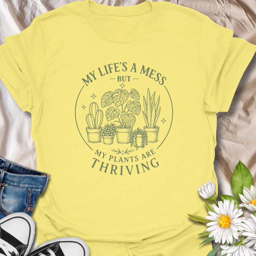 Plants Are Thriving t-shirt for anyone whose life may be messy, but whose houseplants are somehow doing beautifully.
The simple botanical line-art design gives the shirt a clean, relaxed look with relatable plant lover humor.
It is perfect for plant moms, indoor gardeners, houseplant collectors, and anyone who measures success by healthy leaves.
A funny gift for plant people who may not have everything together, but definitely have thriving plants.