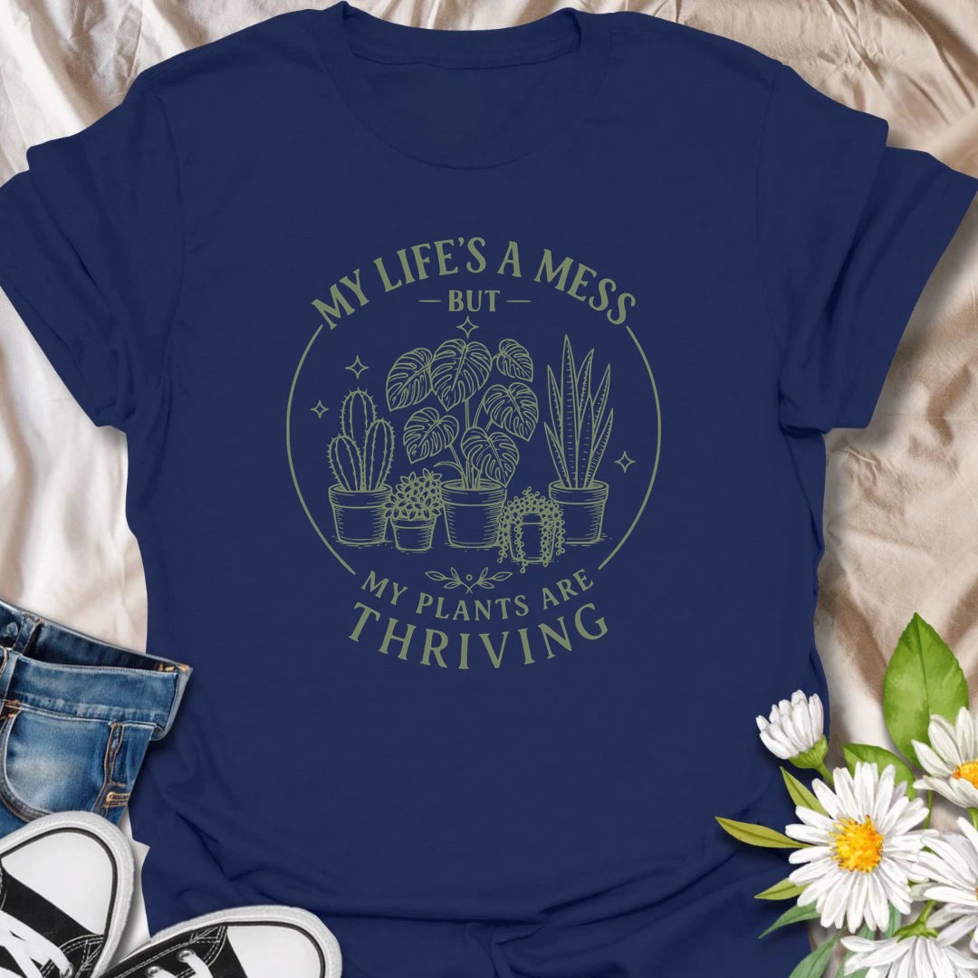 Plants Are Thriving t-shirt for anyone whose life may be messy, but whose houseplants are somehow doing beautifully.
The simple botanical line-art design gives the shirt a clean, relaxed look with relatable plant lover humor.
It is perfect for plant moms, indoor gardeners, houseplant collectors, and anyone who measures success by healthy leaves.
A funny gift for plant people who may not have everything together, but definitely have thriving plants.