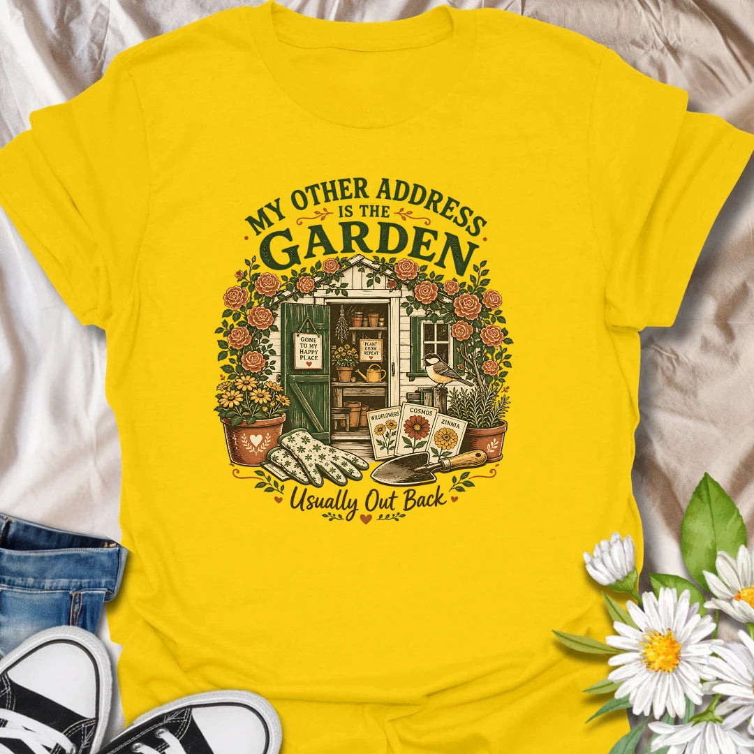 Garden shed t-shirt for plant lovers who feel most at home outside among roses, seed packets, gloves, and garden tools.