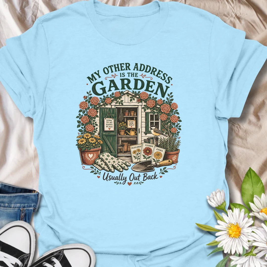 Garden shed t-shirt for plant lovers who feel most at home outside among roses, seed packets, gloves, and garden tools.