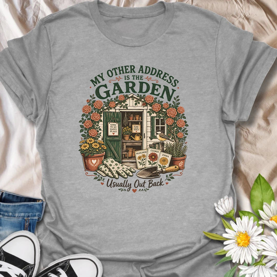 Garden shed t-shirt for plant lovers who feel most at home outside among roses, seed packets, gloves, and garden tools.