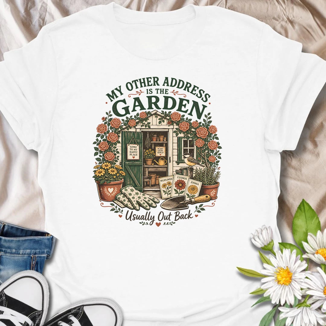Garden shed t-shirt for plant lovers who feel most at home outside among roses, seed packets, gloves, and garden tools.