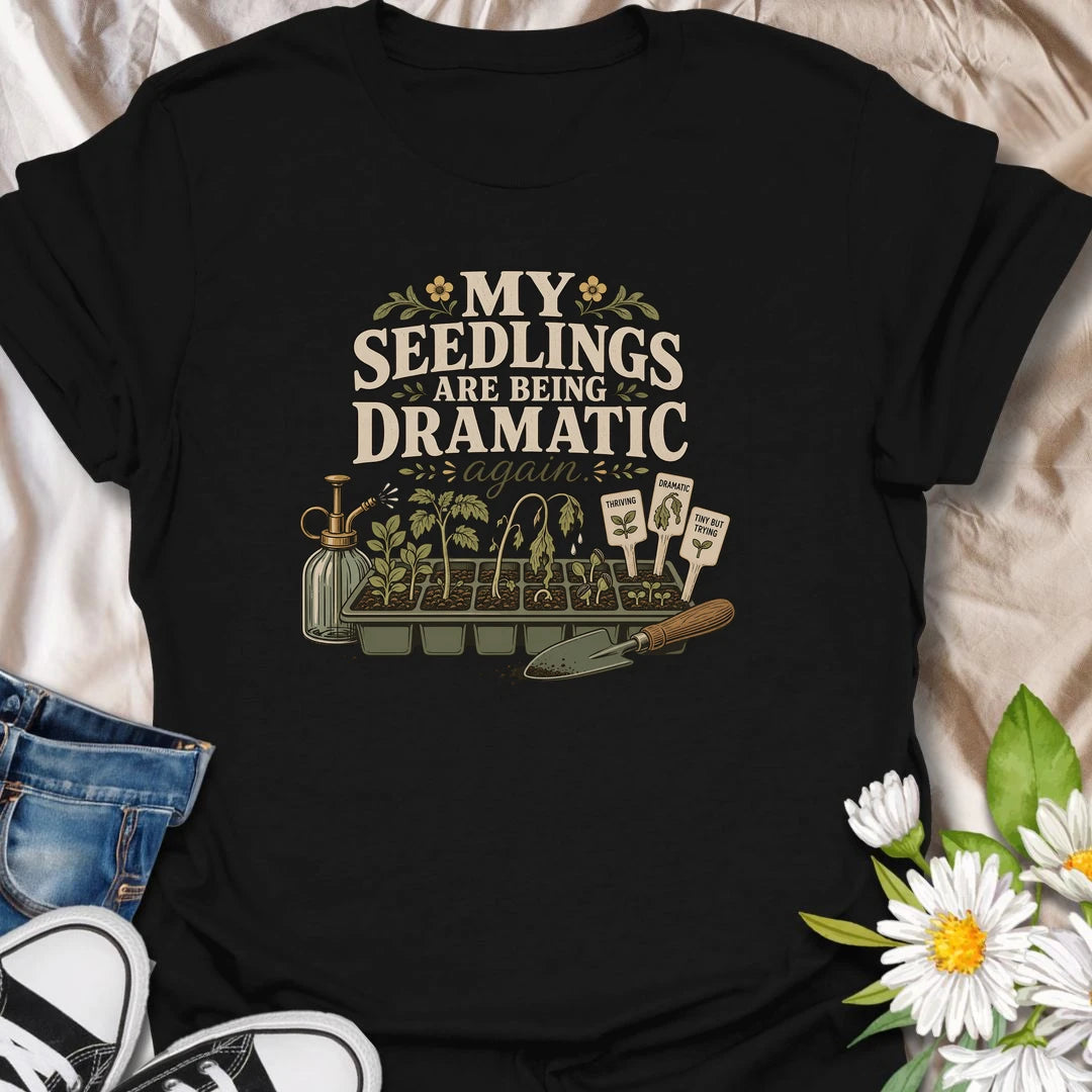 Seed-starting season comes with plenty of drama, and this funny gardening T-shirt understands. Featuring the phrase “My Seedlings Are Being Dramatic Again,” it includes wilted sprouts, plant markers, a mister, and a hand trowel. A perfect gift for vegetable gardeners and seed-starting enthusiasts.