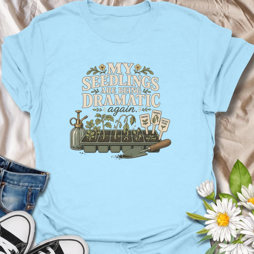 Seed-starting season comes with plenty of drama, and this funny gardening T-shirt understands. Featuring the phrase “My Seedlings Are Being Dramatic Again,” it includes wilted sprouts, plant markers, a mister, and a hand trowel. A perfect gift for vegetable gardeners and seed-starting enthusiasts.