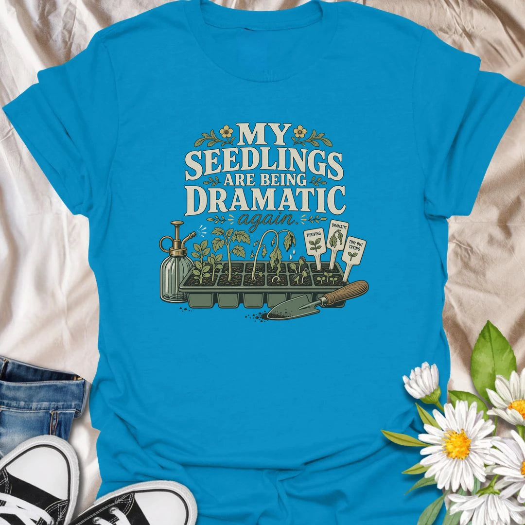 Seed-starting season comes with plenty of drama, and this funny gardening T-shirt understands. Featuring the phrase “My Seedlings Are Being Dramatic Again,” it includes wilted sprouts, plant markers, a mister, and a hand trowel. A perfect gift for vegetable gardeners and seed-starting enthusiasts.