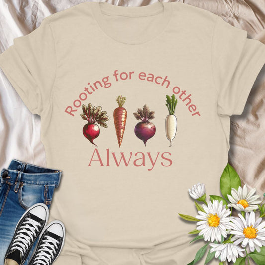 Playful vegetable pun t-shirt featuring carrots, beets, turnips, and radishes with the phrase ‘Rooting for each other always.’ A perfect gift for gardeners, veggie lovers, plant moms, and anyone who loves wholesome humor and plant-based designs