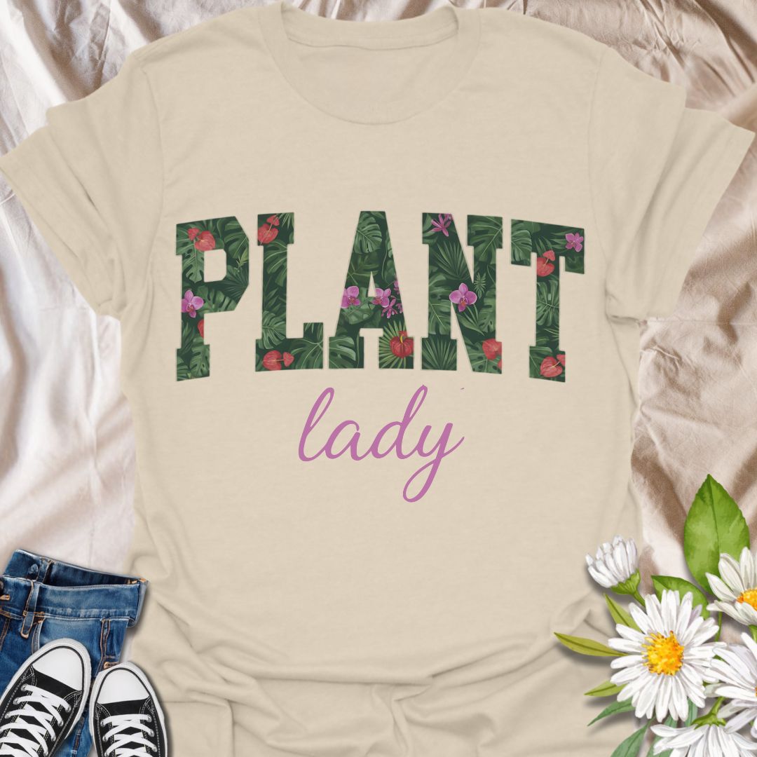 Show off your green thumb in style with this vibrant “Plant Lady” graphic t-shirt featuring bold botanical lettering and a feminine touch. Perfect for plant moms, garden lovers, and anyone who proudly embraces their love for all things leafy and green.
