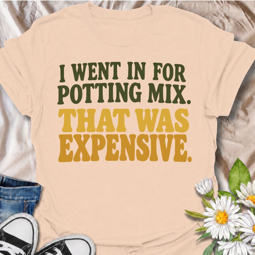 A funny plant T-shirt for anyone who went to the garden center for one bag of potting mix and somehow spent far more than planned. The phrase “I Went In for Potting Mix. That Was Expensive.” delivers dry, relatable humor for plant parents, houseplant collectors, and nursery regulars. Its bold retro typography keeps the design simple, readable, and easy to wear. It makes a great gift for plant lovers who know a “quick trip” for supplies rarely stays cheap. Perfect for nursery visits, garden centers, plant sw