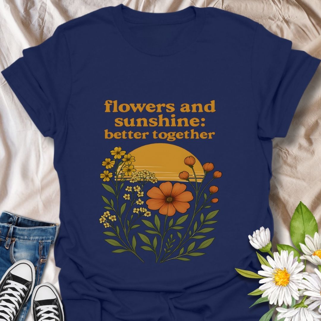 Vintage-inspired floral graphic t-shirt featuring a vibrant sunset and wildflowers. 'Flowers and sunshine: better together' design on soft cornsilk color fabric. Perfect casual wear for nature lovers, flower enthusiasts, and boho style fans. Great gift for outdoor lovers, spring and summer fashion.