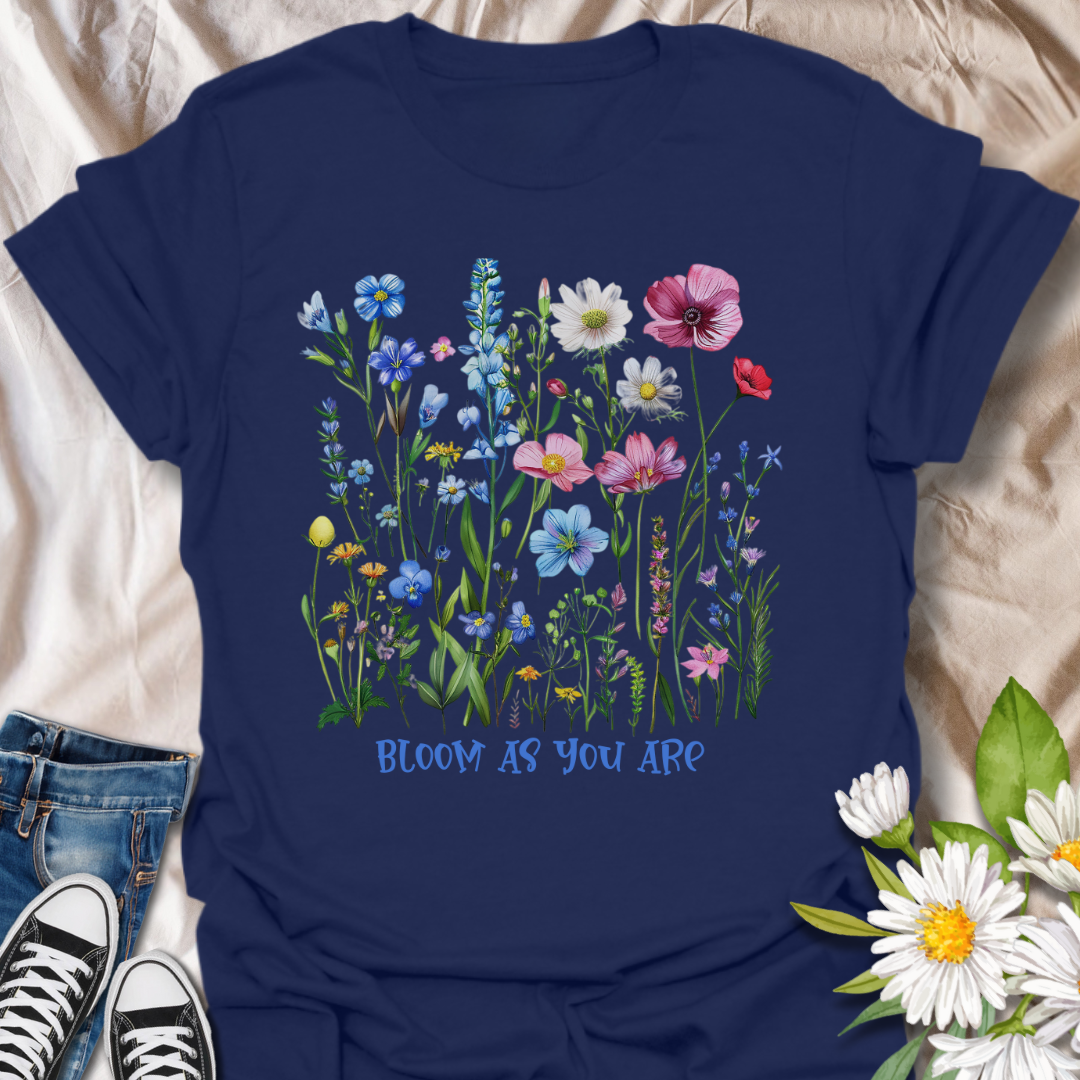 Empowering floral t-shirt featuring a vibrant wildflower garden and the phrase 'Bloom as you are.' A nature-positive, uplifting design for flower lovers, gardeners, and anyone who appreciates self-growth and beauty in every stage. Ideal for gifting or everyday wear with heart