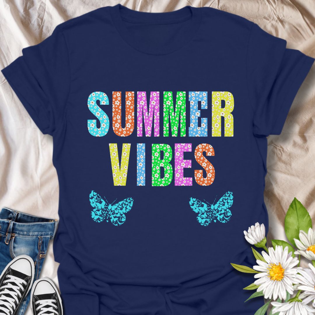 Bright and colorful "Summer Vibes" t-shirt with bold floral letters and butterfly accents. Perfect summer fashion for beach trips, vacations, festivals, or casual days. Ideal gift for anyone who loves sunshine, flowers, and vibrant summer style.