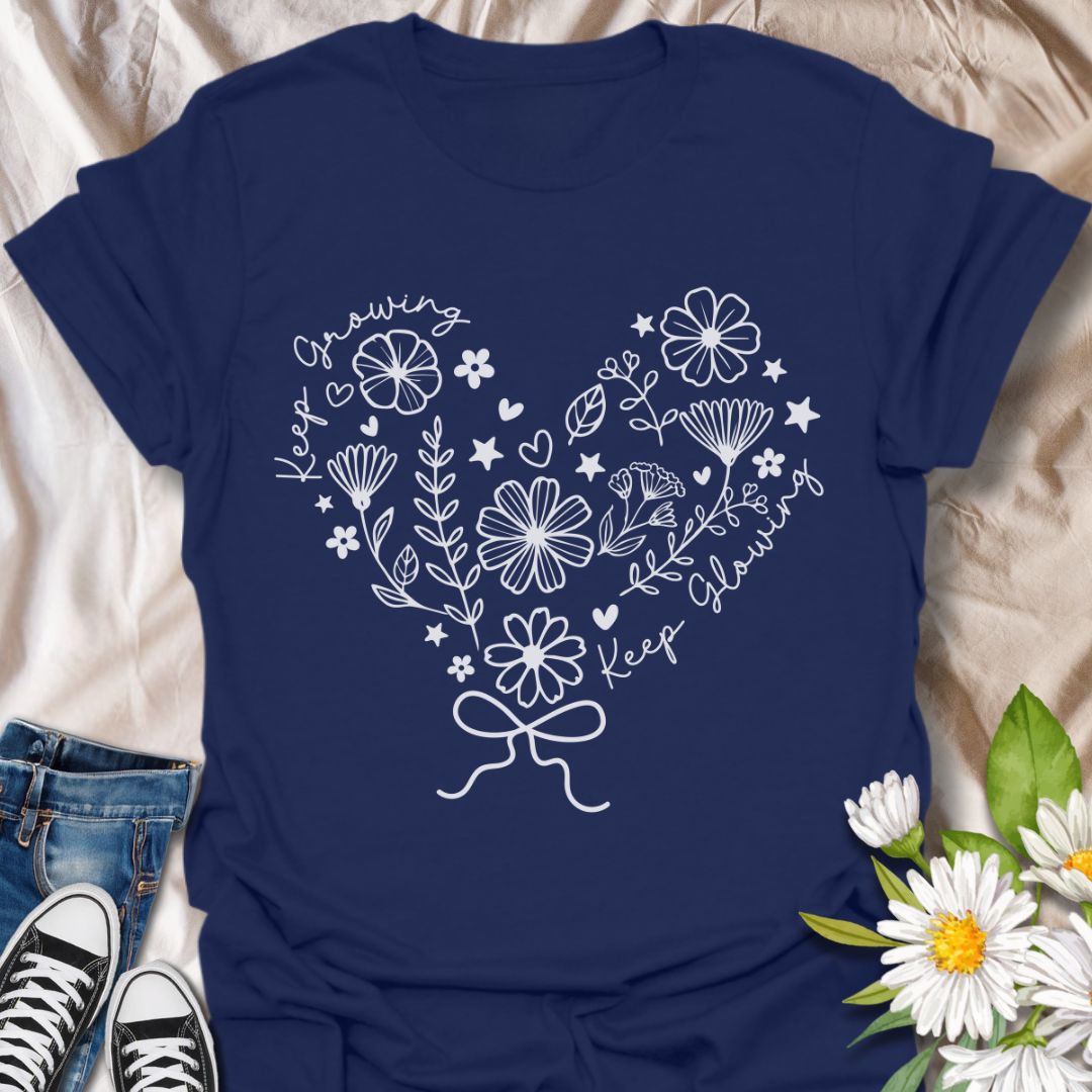 Charming floral heart t-shirt featuring delicate hand-drawn flowers with positive affirmations “Keep Growing, Keep Glowing.” A perfect uplifting gift for gardeners and plant lovers. Navy