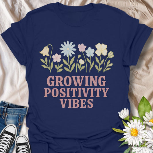 Radiate good energy with this “Growing Positivity Vibes” t-shirt featuring pastel wildflowers on a navy blue tee. A perfect uplifting gift for plant lovers, garden enthusiasts, and anyone who embraces a cheerful, kind-hearted lifestyle.