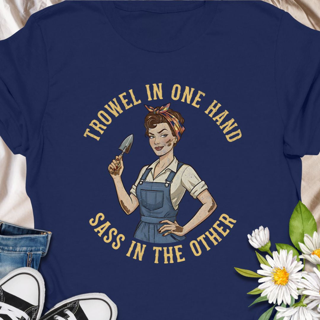A bold, vintage-inspired gardening t-shirt featuring the phrase “Trowel in One Hand, Sass in the Other.” Perfect for confident gardeners, plant moms, and anyone who loves humor, dirt, and a little attitude in the garden.