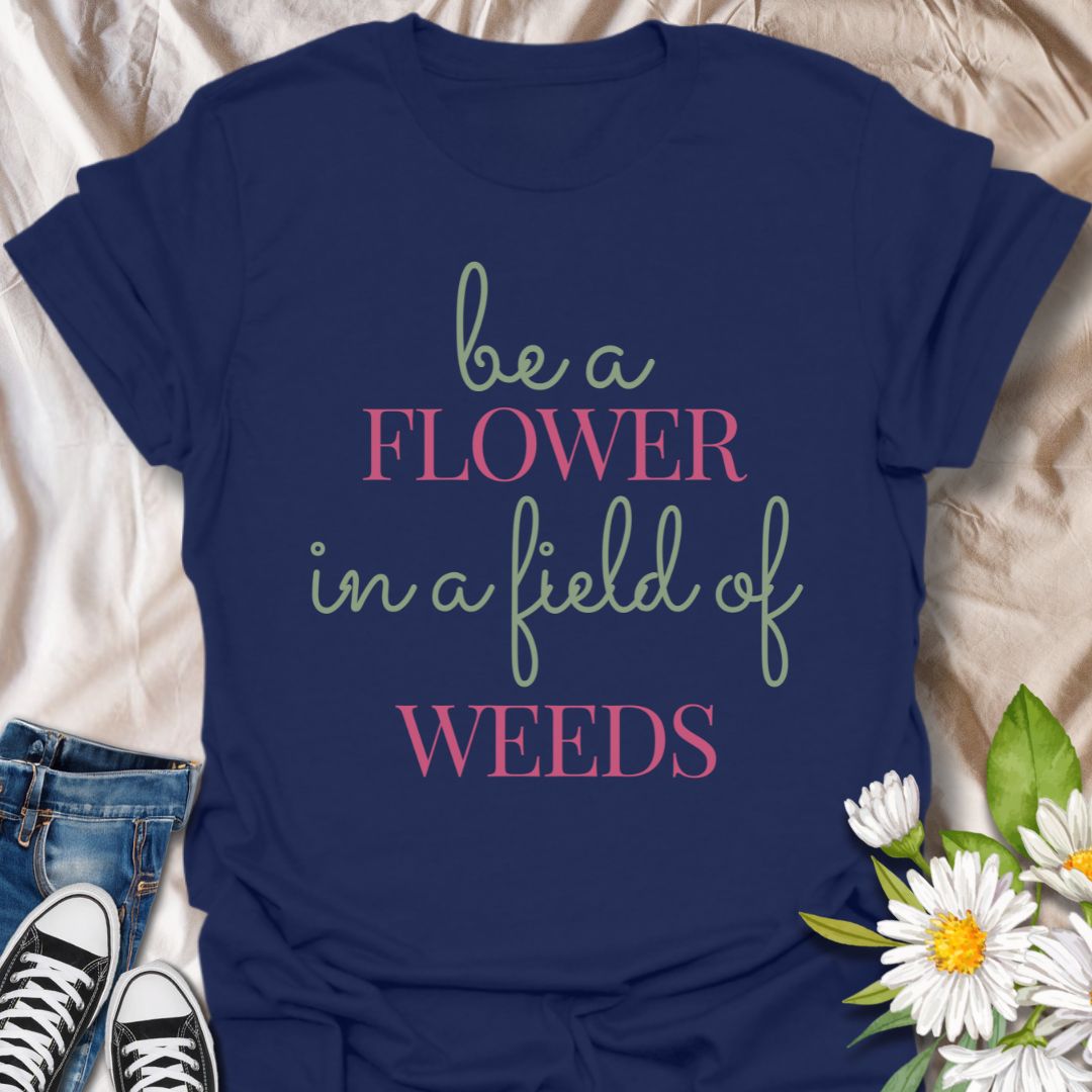 Stand out with this inspirational graphic t-shirt featuring the motivational phrase "Be a Flower in a Field of Weeds." Perfect for positivity seekers, nature lovers, and anyone who enjoys uplifting, floral-themed apparel with a meaningful message.