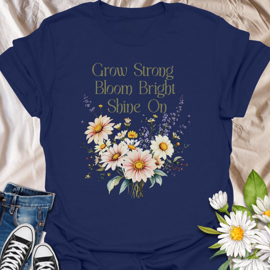 Embrace positivity and growth with this beautifully designed floral t-shirt featuring the empowering phrase "Grow Strong, Bloom Bright, Shine On". This tee has a vibrant bouquet of daisies and wildflowers, this inspirational tee is perfect for nature lovers, garden enthusiasts, teachers, or anyone who believes in blooming through life’s seasons. A thoughtful gift for those who radiate light and strength.