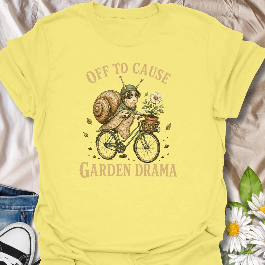 This Off To Cause Garden Drama t-shirt is perfect for gardeners, snail lovers, and plant people with a playful sense of humor. Featuring a vintage-style snail riding a bicycle with a flower pot and botanical details, this funny garden design is great for plant lovers, cottagecore fans, nature lovers, and anyone who enjoys whimsical garden chaos.