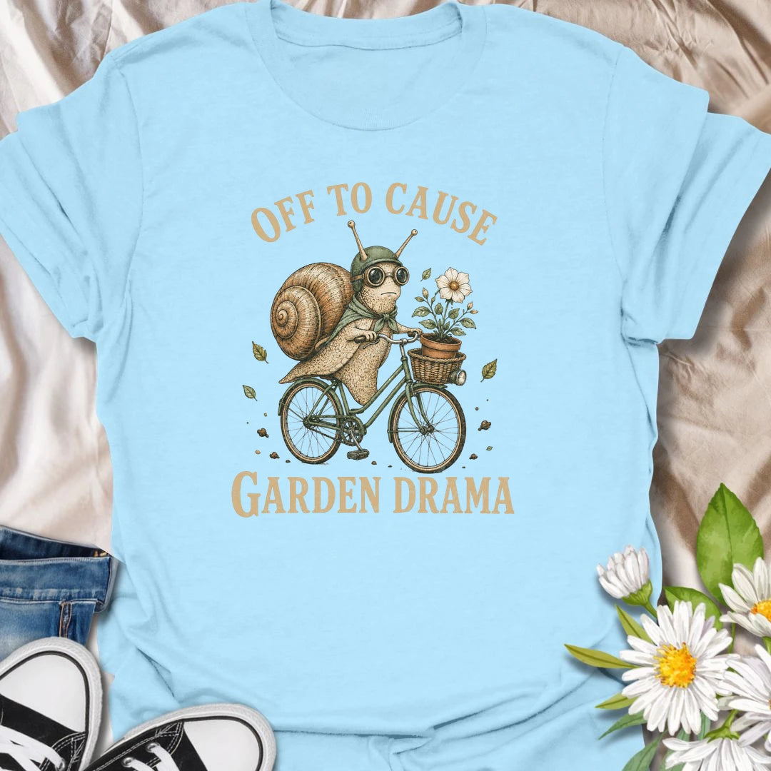 This Off To Cause Garden Drama t-shirt is perfect for gardeners, snail lovers, and plant people with a playful sense of humor. Featuring a vintage-style snail riding a bicycle with a flower pot and botanical details, this funny garden design is great for plant lovers, cottagecore fans, nature lovers, and anyone who enjoys whimsical garden chaos.
