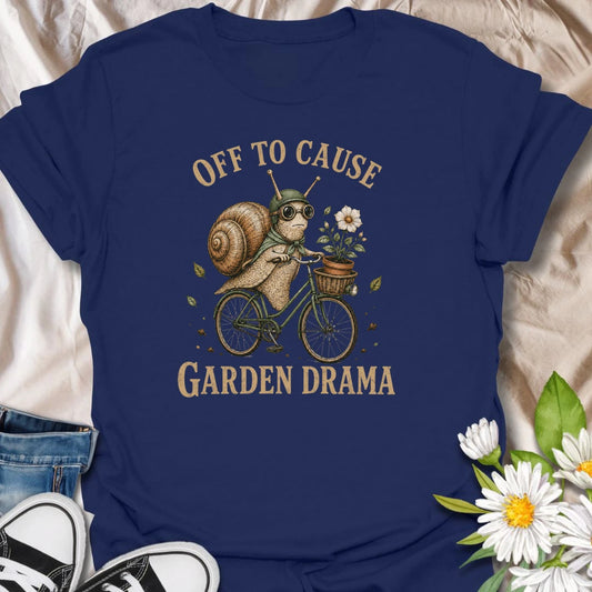 This Off To Cause Garden Drama t-shirt is perfect for gardeners, snail lovers, and plant people with a playful sense of humor. Featuring a vintage-style snail riding a bicycle with a flower pot and botanical details, this funny garden design is great for plant lovers, cottagecore fans, nature lovers, and anyone who enjoys whimsical garden chaos.