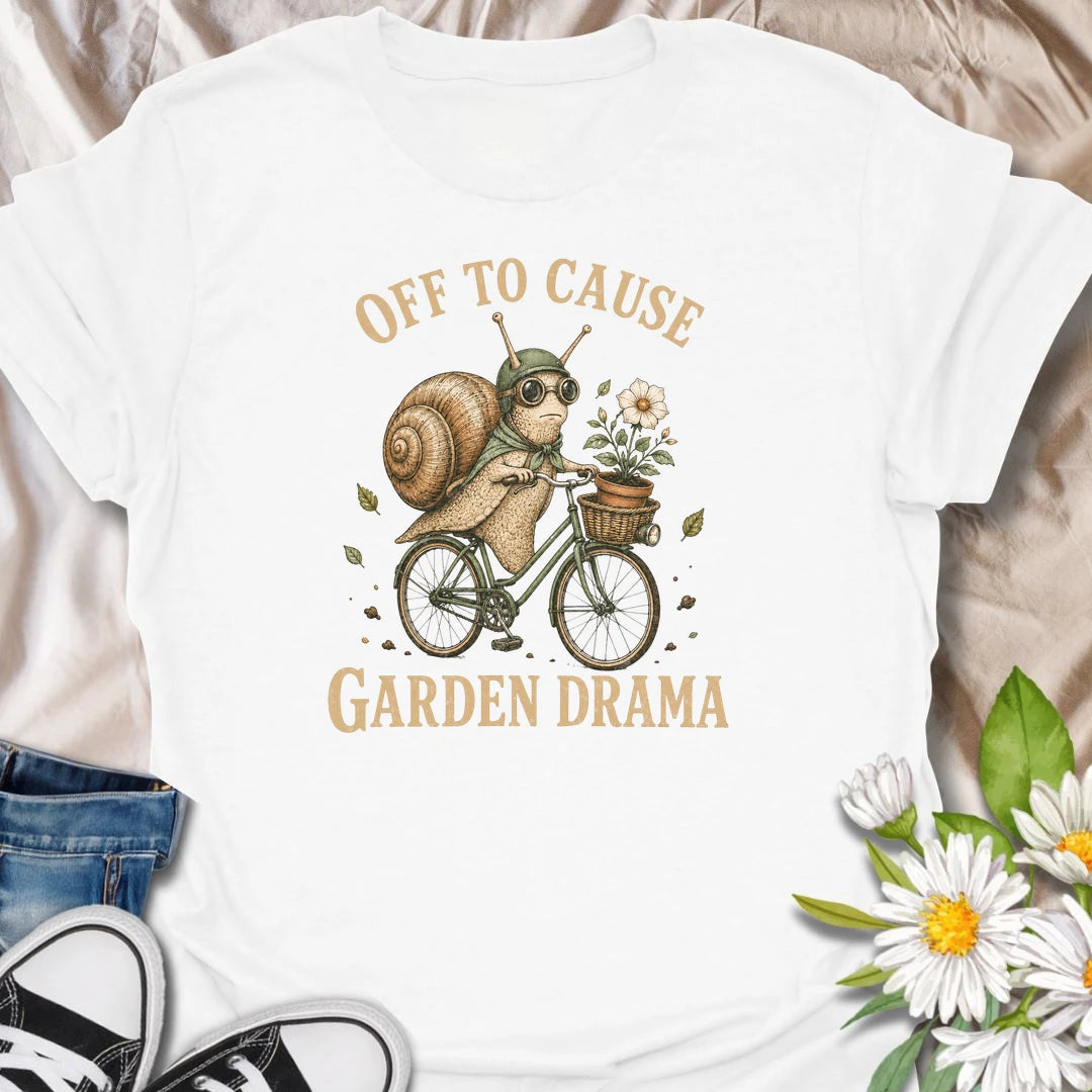 This Off To Cause Garden Drama t-shirt is perfect for gardeners, snail lovers, and plant people with a playful sense of humor. Featuring a vintage-style snail riding a bicycle with a flower pot and botanical details, this funny garden design is great for plant lovers, cottagecore fans, nature lovers, and anyone who enjoys whimsical garden chaos.