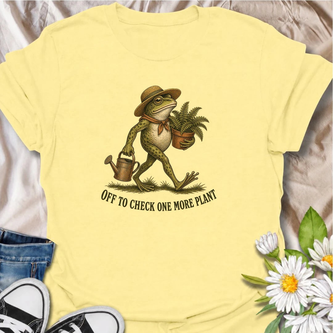 A funny plant T-shirt for anyone who can never resist checking on just one more plant. Featuring a charming vintage-style frog carrying a fern and watering can, this design is perfect for plant parents, gardeners, and nursery regulars. The phrase “Off to Check One More Plant” captures the familiar habit of turning a quick plant check into a much longer wander. It makes a great gift for houseplant lovers, garden enthusiasts, frog lovers, and anyone whose plants get more attention than most people. Ideal for 