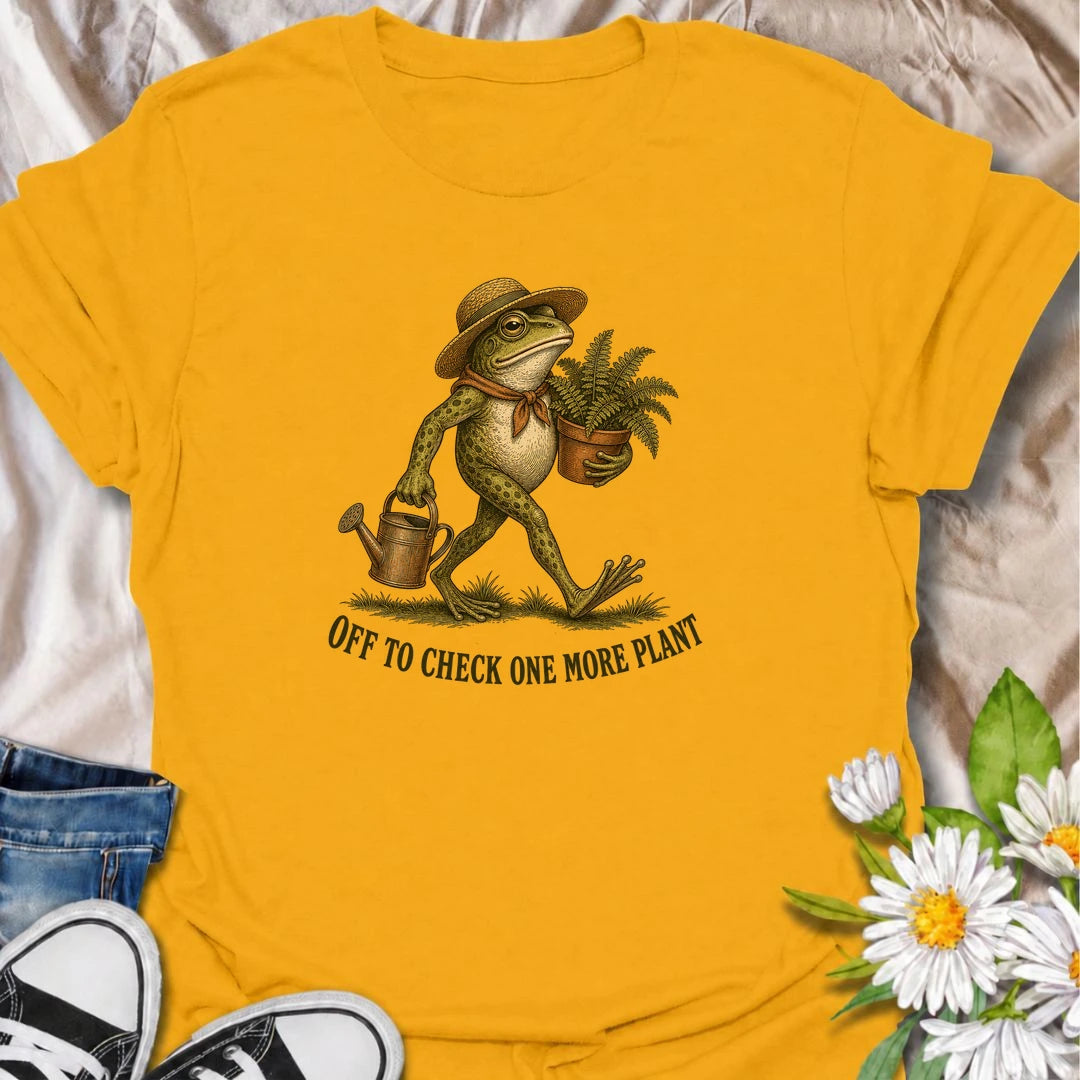 A funny plant T-shirt for anyone who can never resist checking on just one more plant. Featuring a charming vintage-style frog carrying a fern and watering can, this design is perfect for plant parents, gardeners, and nursery regulars. The phrase “Off to Check One More Plant” captures the familiar habit of turning a quick plant check into a much longer wander. It makes a great gift for houseplant lovers, garden enthusiasts, frog lovers, and anyone whose plants get more attention than most people. Ideal for 
