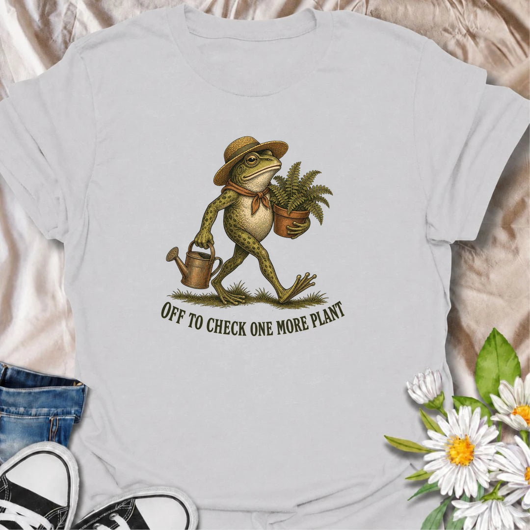 A funny plant T-shirt for anyone who can never resist checking on just one more plant. Featuring a charming vintage-style frog carrying a fern and watering can, this design is perfect for plant parents, gardeners, and nursery regulars. The phrase “Off to Check One More Plant” captures the familiar habit of turning a quick plant check into a much longer wander. It makes a great gift for houseplant lovers, garden enthusiasts, frog lovers, and anyone whose plants get more attention than most people. Ideal for 