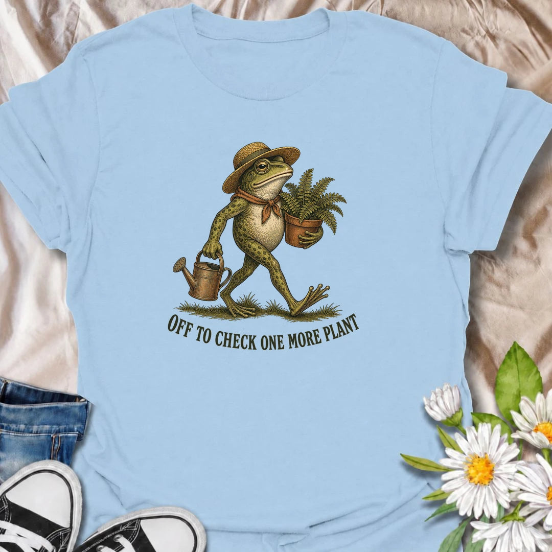A funny plant T-shirt for anyone who can never resist checking on just one more plant. Featuring a charming vintage-style frog carrying a fern and watering can, this design is perfect for plant parents, gardeners, and nursery regulars. The phrase “Off to Check One More Plant” captures the familiar habit of turning a quick plant check into a much longer wander. It makes a great gift for houseplant lovers, garden enthusiasts, frog lovers, and anyone whose plants get more attention than most people. Ideal for 