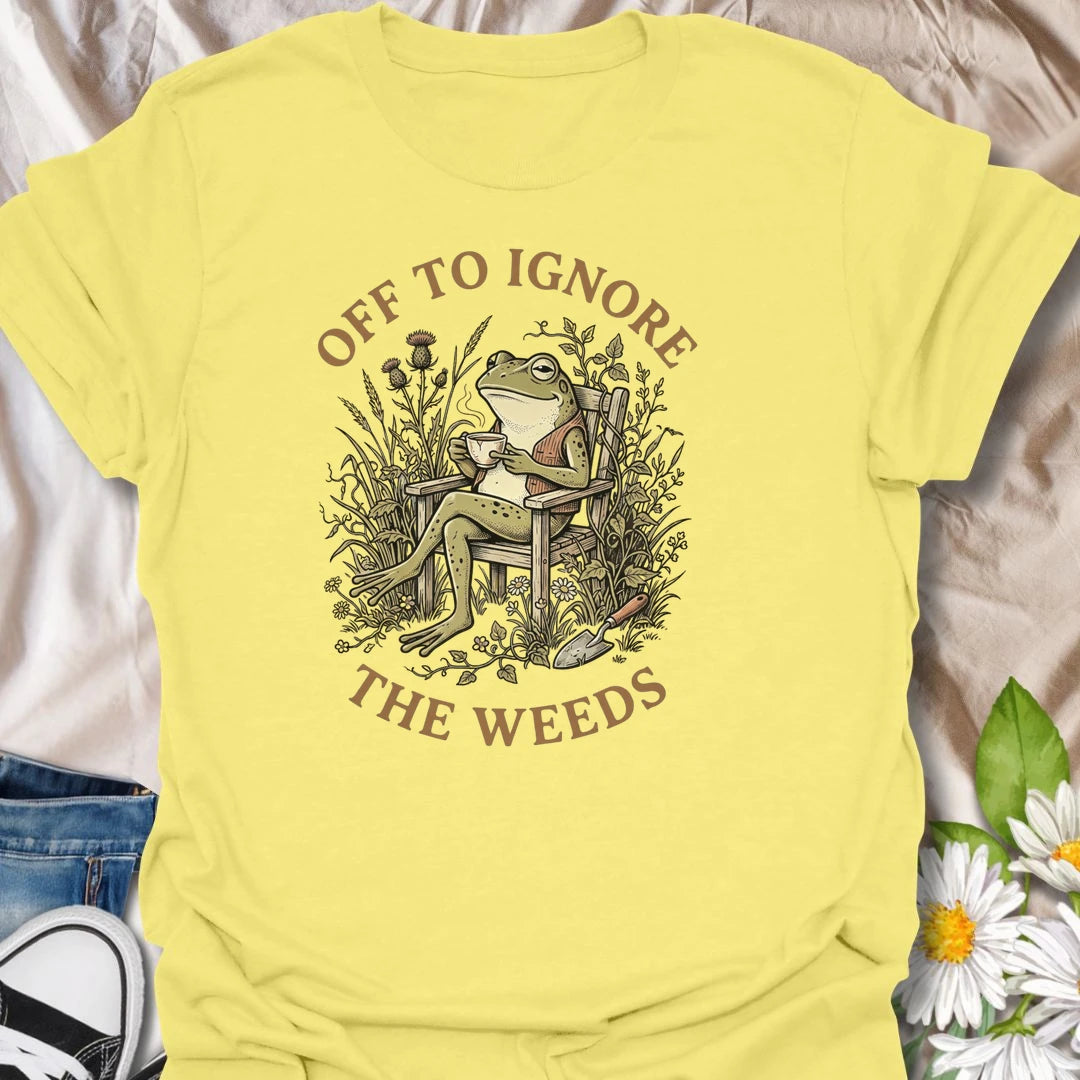 This Off To Ignore The Weeds t-shirt is perfect for gardeners who love the garden but are not always rushing to pull every weed. Featuring a relaxed frog sitting in a garden chair surrounded by plants, flowers, and overgrown greenery, this funny botanical design is great for plant lovers, backyard gardeners, cottage garden fans, frog lovers, and anyone who believes weeds can wait.