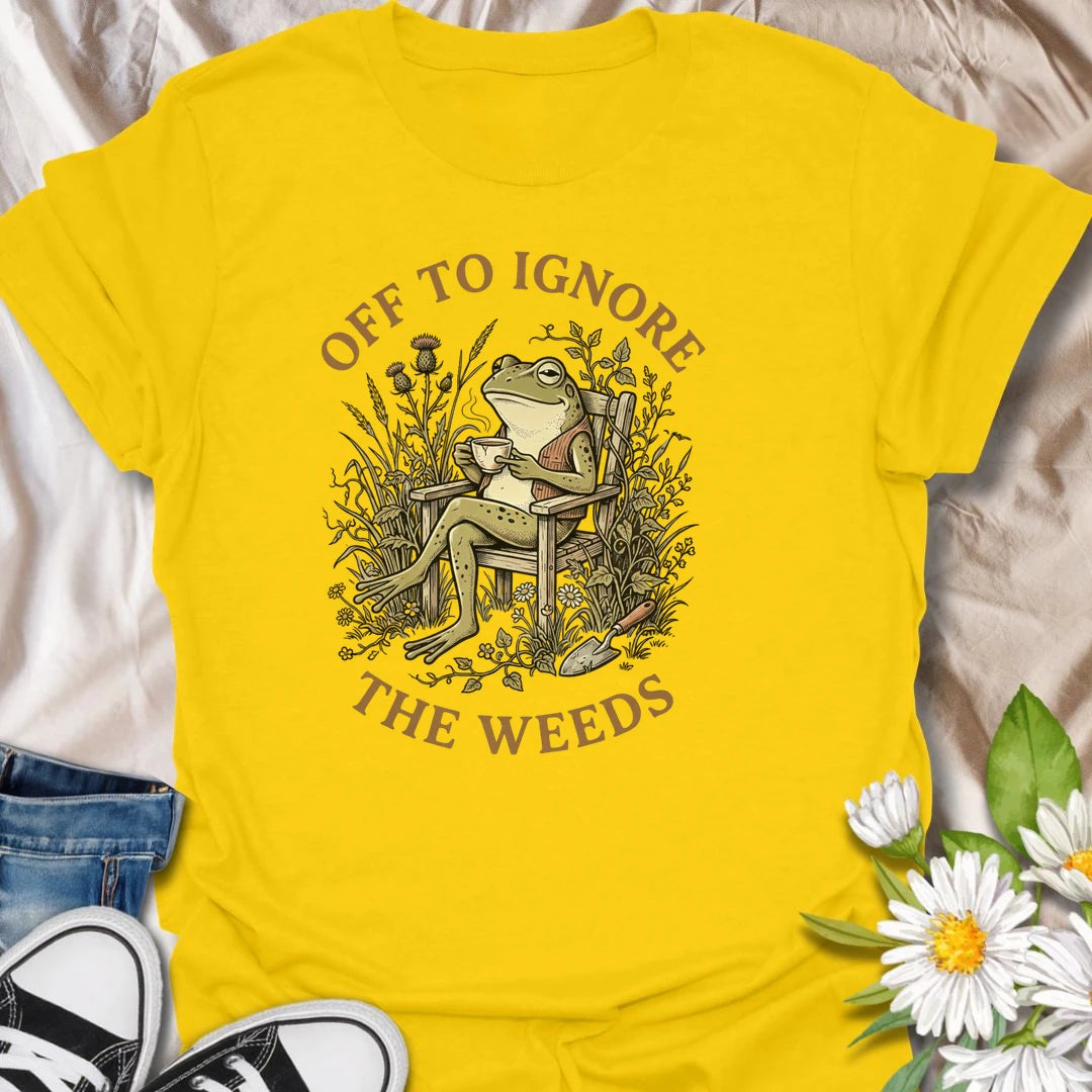 This Off To Ignore The Weeds t-shirt is perfect for gardeners who love the garden but are not always rushing to pull every weed. Featuring a relaxed frog sitting in a garden chair surrounded by plants, flowers, and overgrown greenery, this funny botanical design is great for plant lovers, backyard gardeners, cottage garden fans, frog lovers, and anyone who believes weeds can wait.