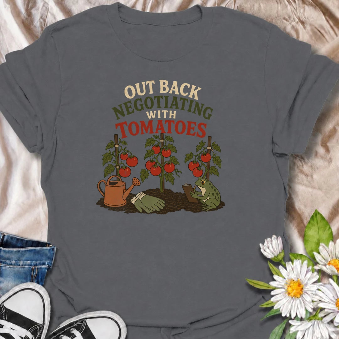 A funny gardening T-shirt for tomato growers who know every plant seems to have its own demands. Featuring ripe tomato plants, gardening tools, and a very serious frog taking notes, this design is perfect for vegetable gardeners with a sense of humor. The “Out Back Negotiating With Tomatoes” phrase makes a fun gift for backyard growers, allotment gardeners, and anyone who spends more time talking to plants than people. Great for garden days, farmers markets, greenhouse visits, or relaxing in the backyard. A