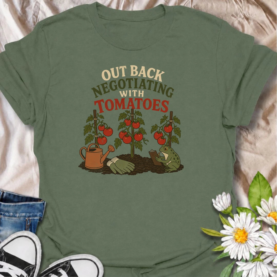 A funny gardening T-shirt for tomato growers who know every plant seems to have its own demands. Featuring ripe tomato plants, gardening tools, and a very serious frog taking notes, this design is perfect for vegetable gardeners with a sense of humor. The “Out Back Negotiating With Tomatoes” phrase makes a fun gift for backyard growers, allotment gardeners, and anyone who spends more time talking to plants than people. Great for garden days, farmers markets, greenhouse visits, or relaxing in the backyard. A