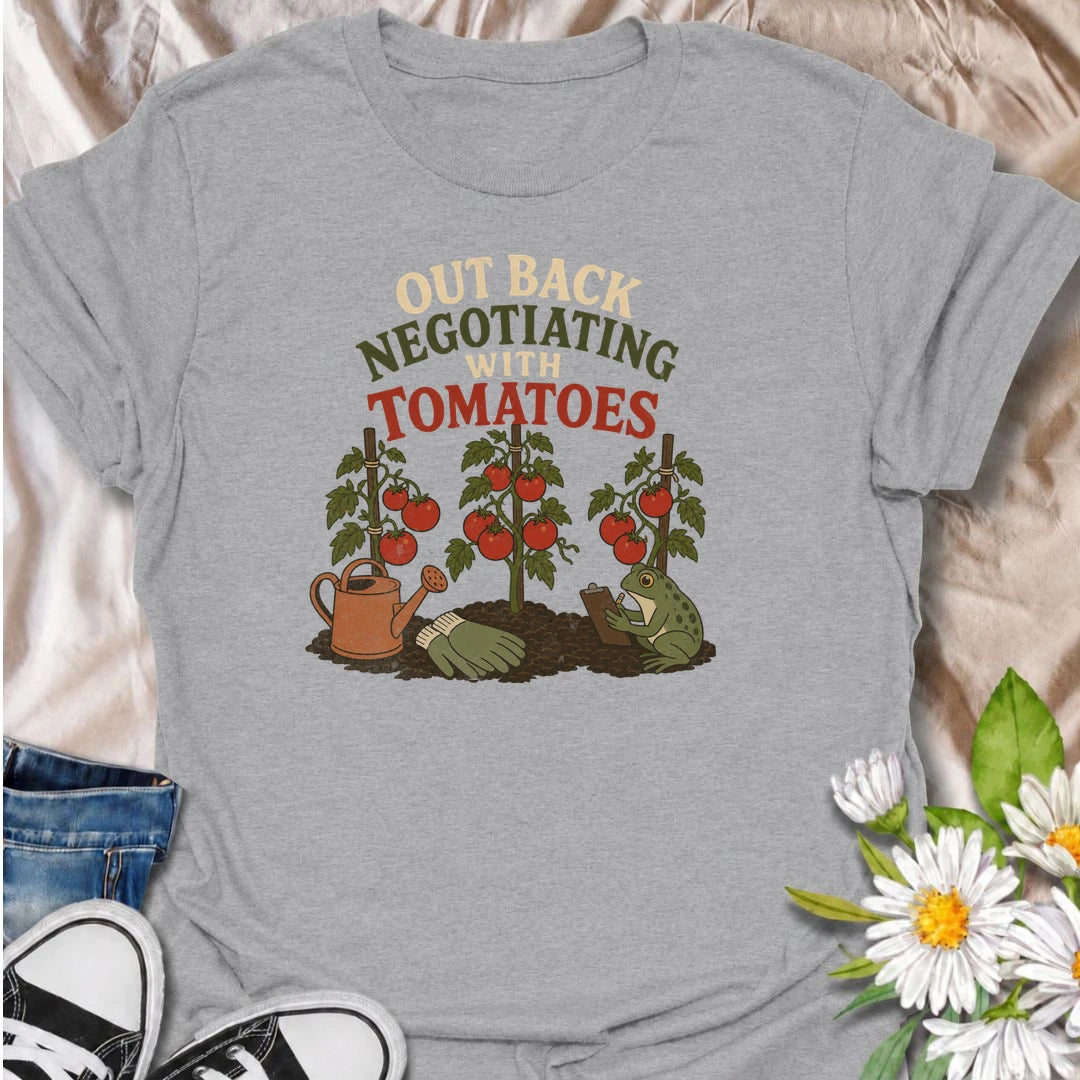 A funny gardening T-shirt for tomato growers who know every plant seems to have its own demands. Featuring ripe tomato plants, gardening tools, and a very serious frog taking notes, this design is perfect for vegetable gardeners with a sense of humor. The “Out Back Negotiating With Tomatoes” phrase makes a fun gift for backyard growers, allotment gardeners, and anyone who spends more time talking to plants than people. Great for garden days, farmers markets, greenhouse visits, or relaxing in the backyard. A